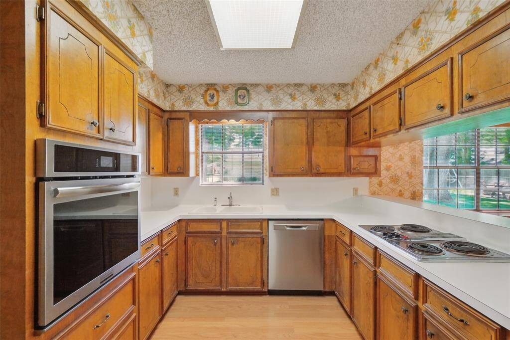 The step-saver Kitchen features a Frigidaire Oven, Dishwasher, and electric Cooktop.