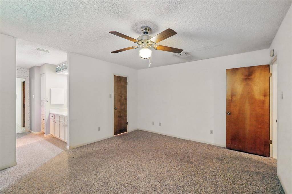 The Primary Bedroom hints of the Bathroom and Closet at center.
