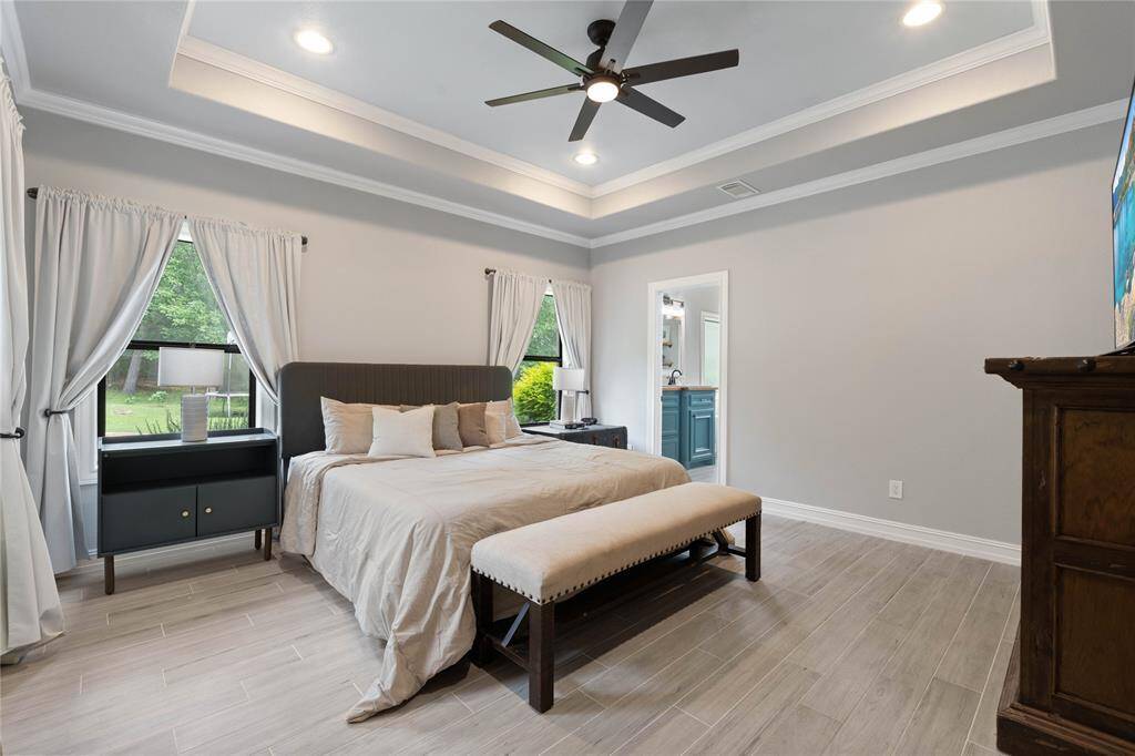 Spacious primary suite with views of pool and yard.