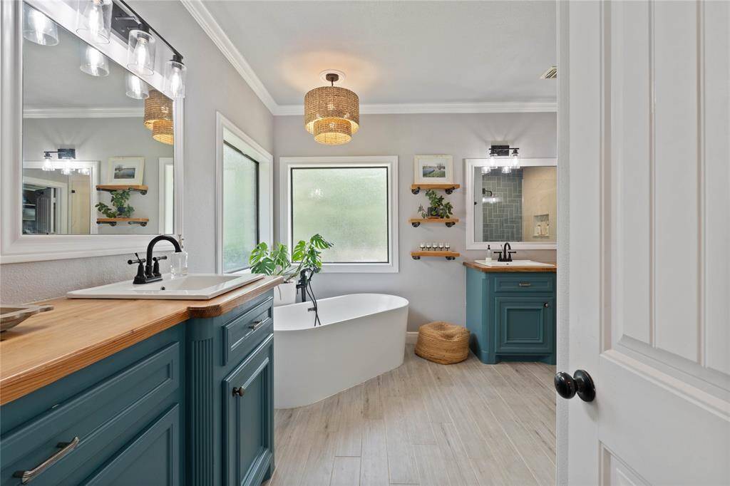 Ensuite with recently updated shower, soaking tub, new flooring and paint, butcher block countertops and fixtures.