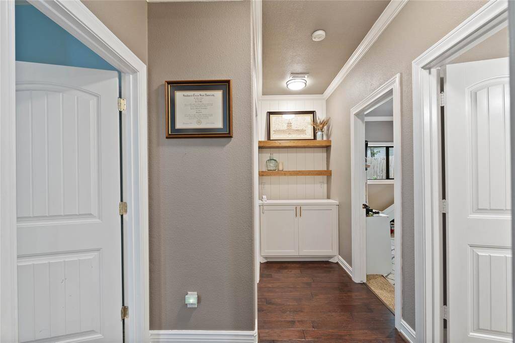 Hallway leading to three bedrooms and flex-space. Custom storage for games or linens.
