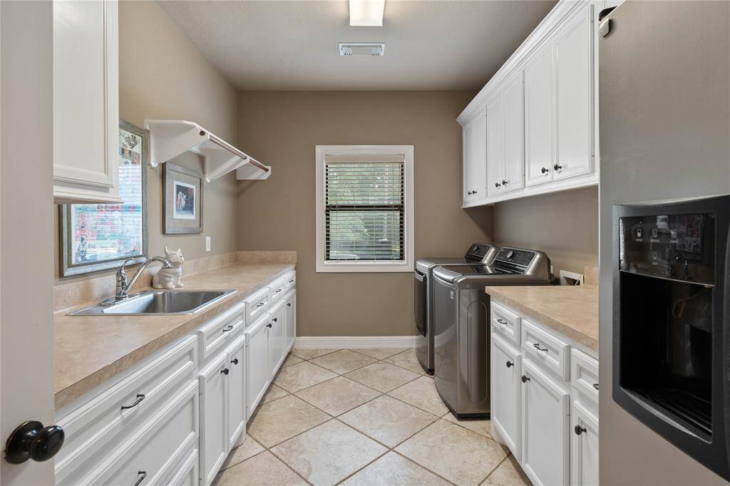 Large laundry room with ample storage and freezer space.
