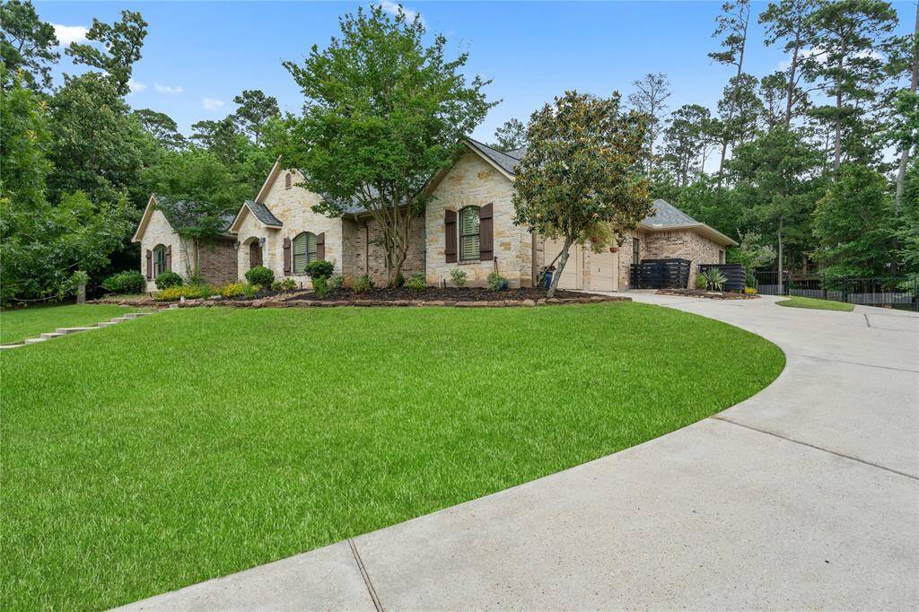Curved driveway leading to additional parking and RV space with hookups.