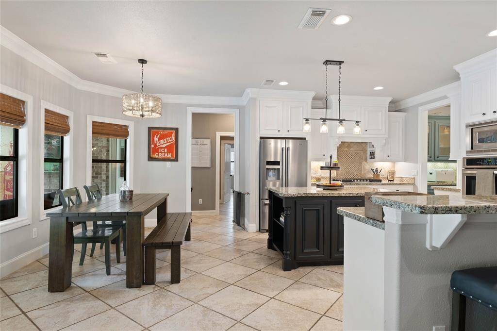 Breakfast nook and kitchen also have view of backyard.