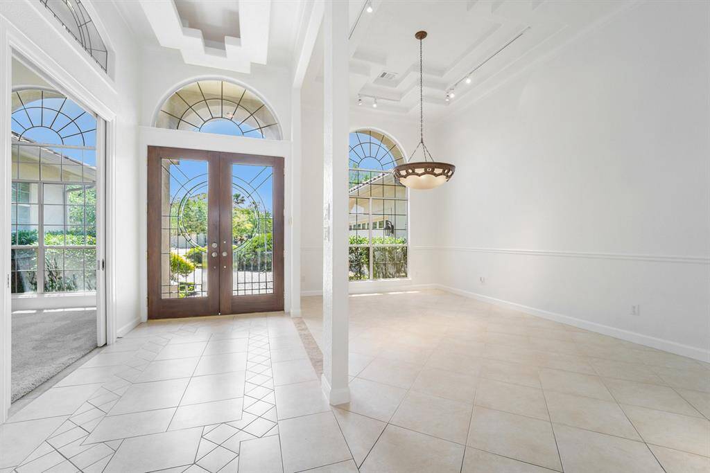 Bright entry way flanked by dining room and home office