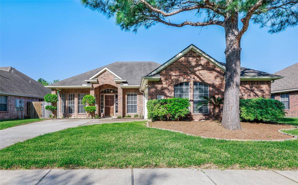 Beautiful front elevation of this one story brick home/landscaping.
