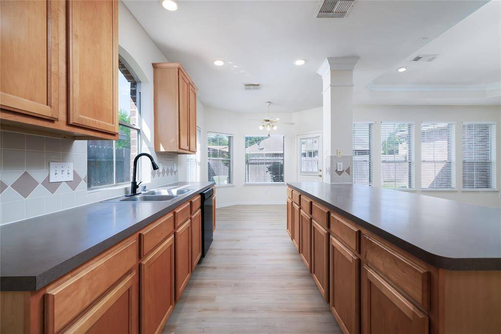 The kitchen looking towards the breakfast area and living room.  So much natural light!