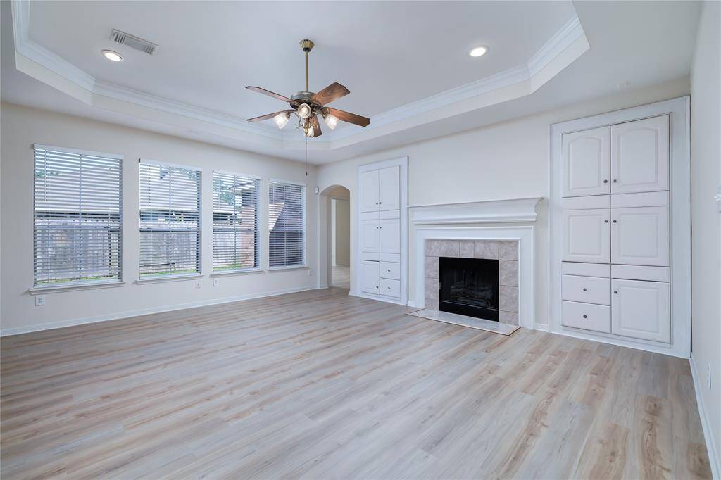 A fireplace/mantle and custom cabinets along with lots of natural light are highlights in the main living room.