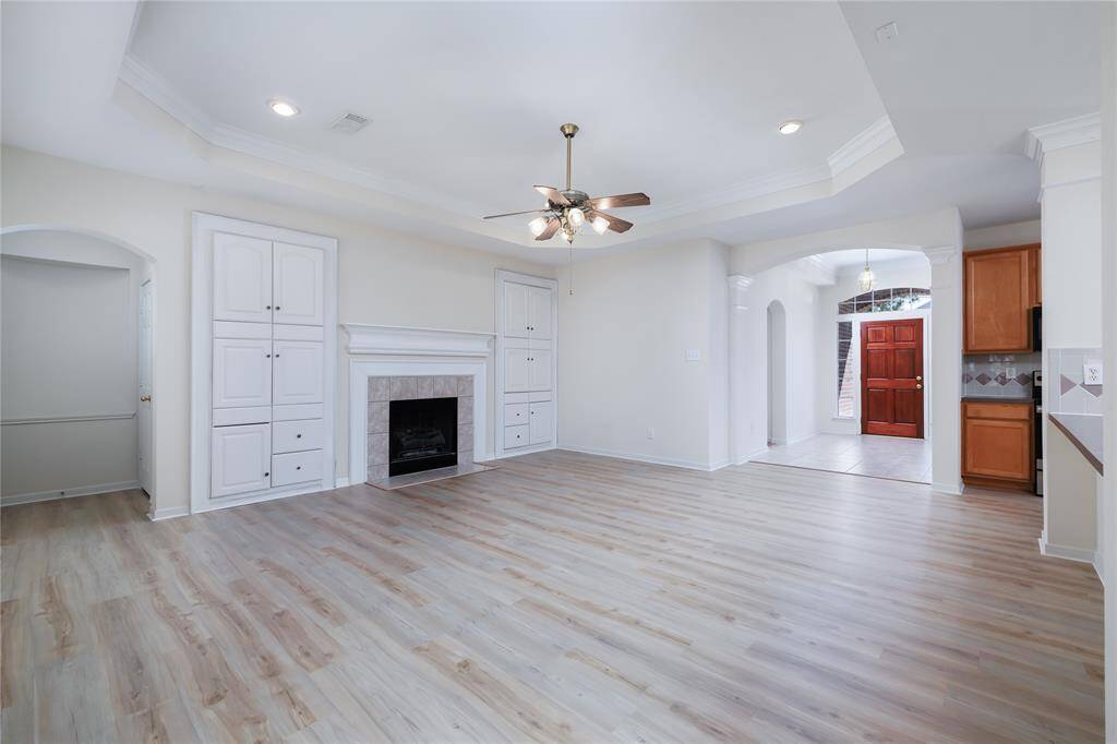 The living room with a raised ceiling looking towards the foyer.