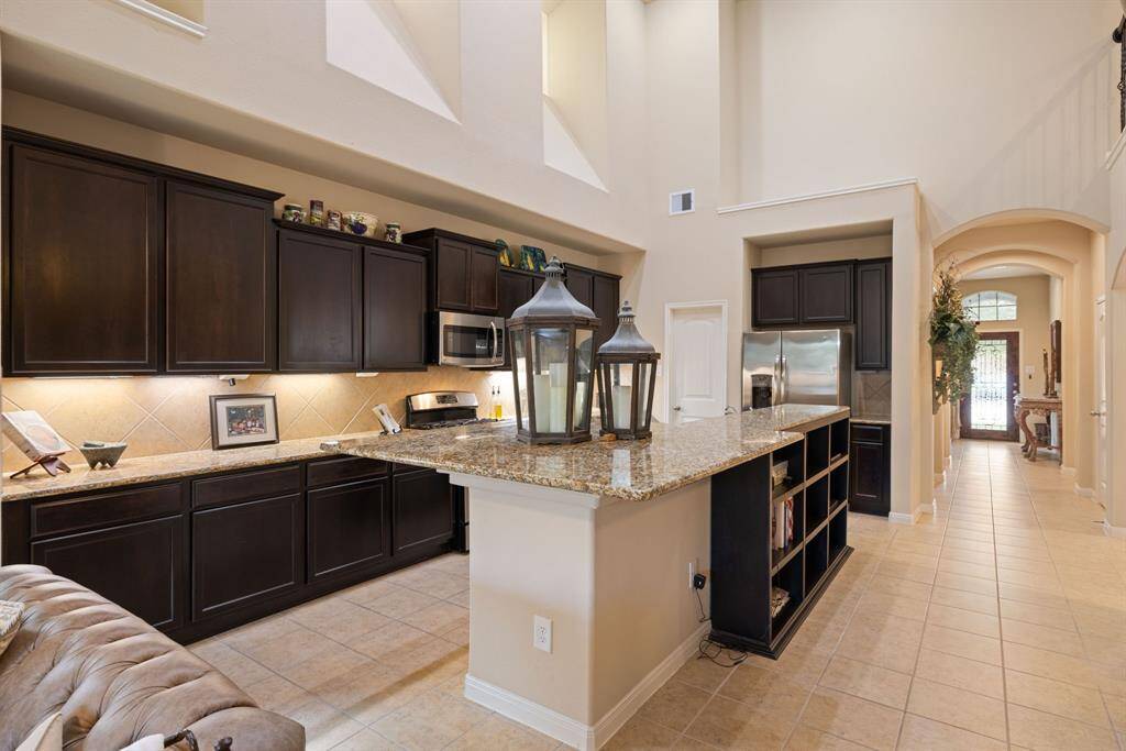 The kitchen's under-cabinet lights have been upgraded to high-quality fixtures, and additional bookshelves have been installed beneath the island kitchen counter.