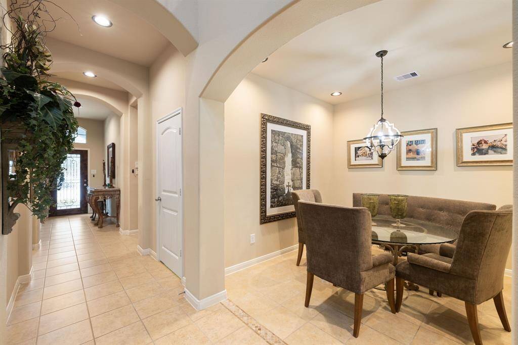 This angle reveals the grand dining room's spacious layout, conveniently situated off the kitchen, perfect for seamless entertaining. Notice the tile transition in this picture. SO many details throughout this home!