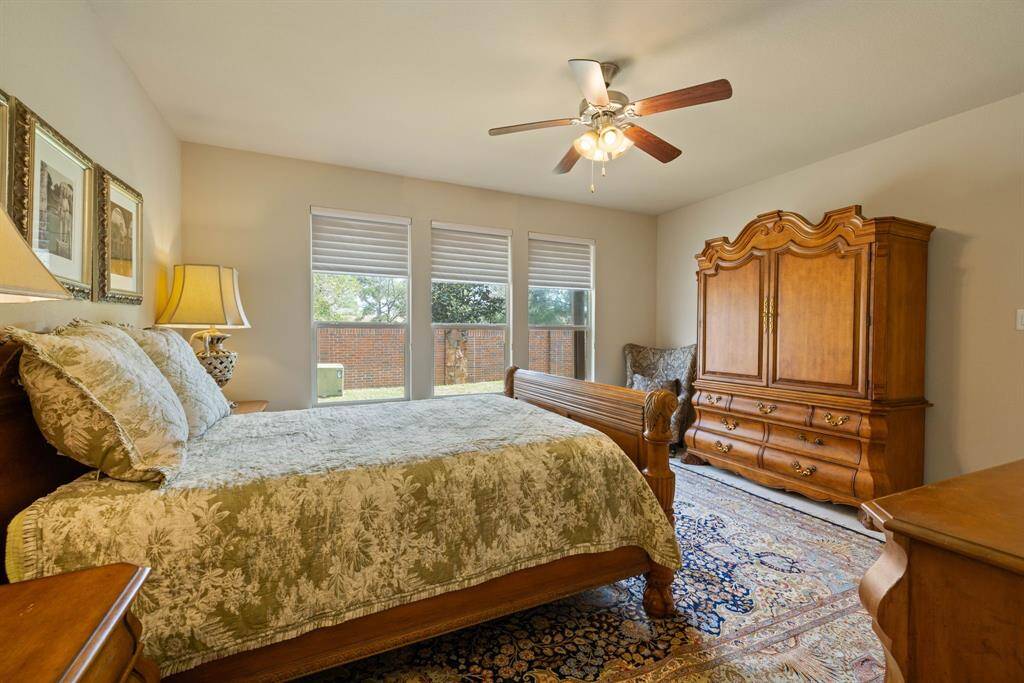 This is a well-lit, spacious room with fabric-vaned blinds herringbone berber carpet and high ceilings.