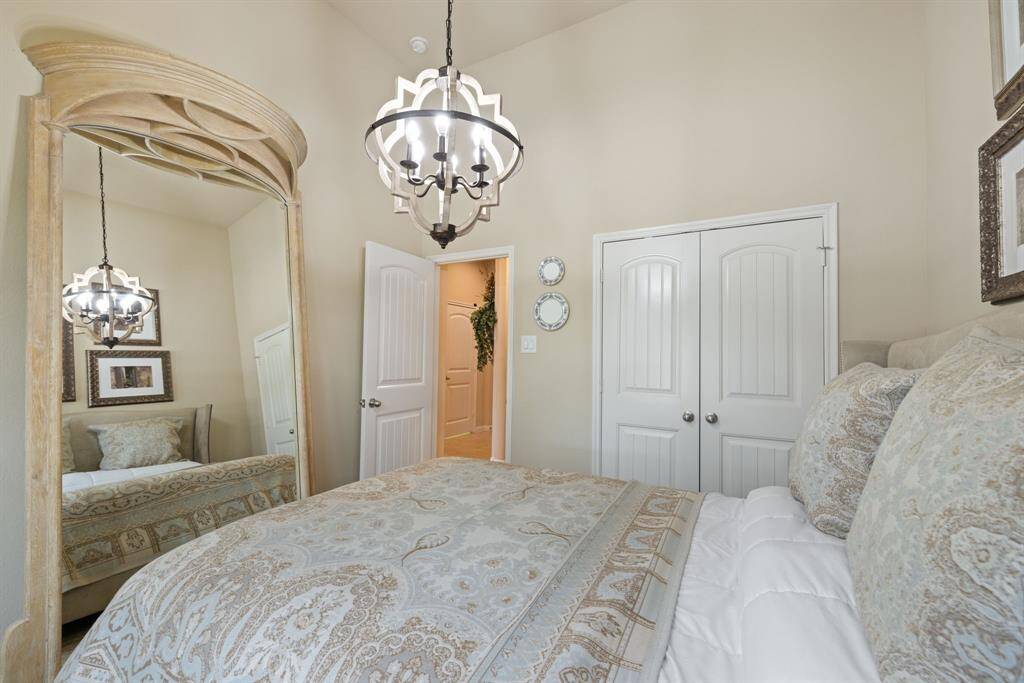 This secondary bedrooms is located on the first floor and features a wall closet, fabric-vaned blinds, upgraded light fixture and herringbone carpet.