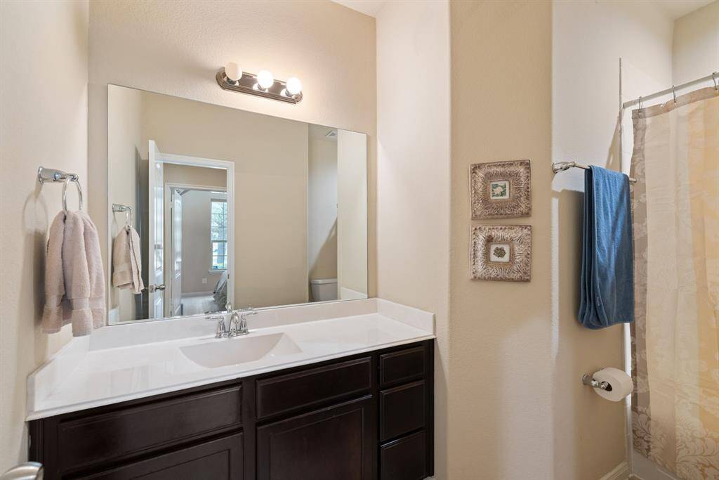 This downstairs bathroom is enhanced with Shelf Genie installations, providing smart and accessible storage solutions that maximize space and convenience.