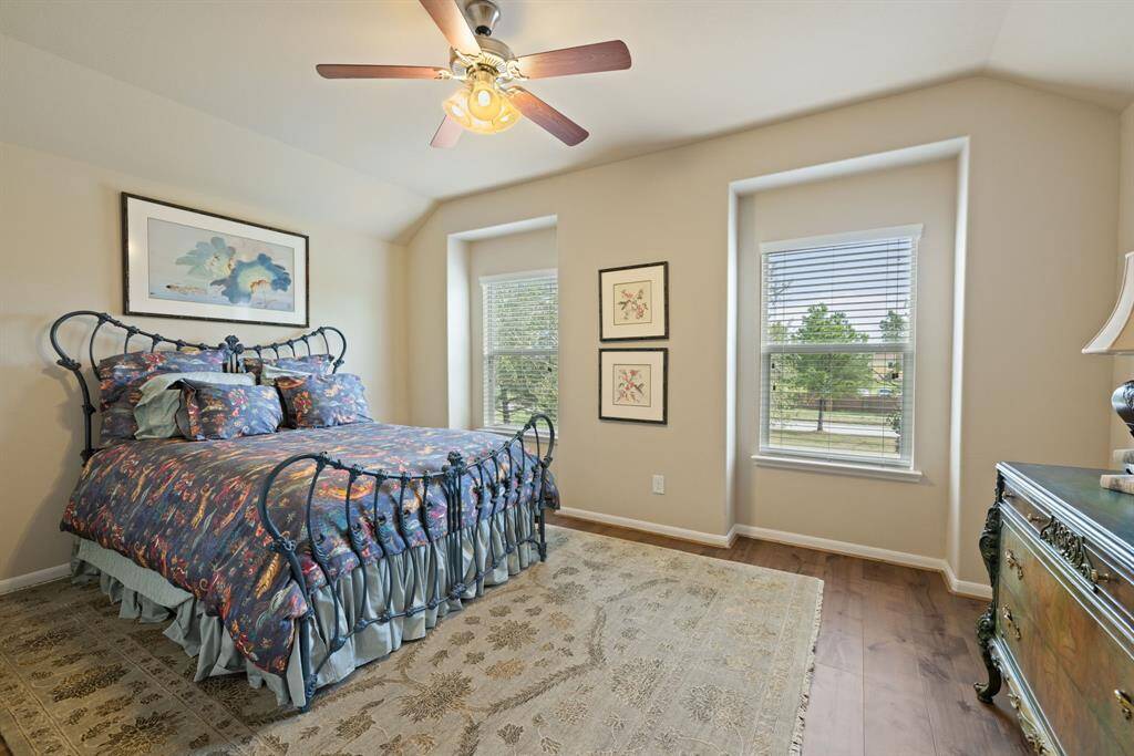The third bedroom, situated on the second floor, features upgraded hardwood floors and a spacious walk-in closet. This inviting space combines comfort and elegance, offering ample room for personalization and storage.