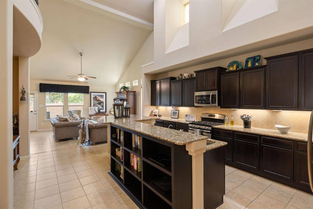 The kitchen is flooded with warm, natural light, creating a bright and inviting atmosphere perfect for morning gatherings. Throughout the home, elegant fabric vaned blinds offer both privacy and soft, filtered light, enhancing the serene ambiance of each room.
