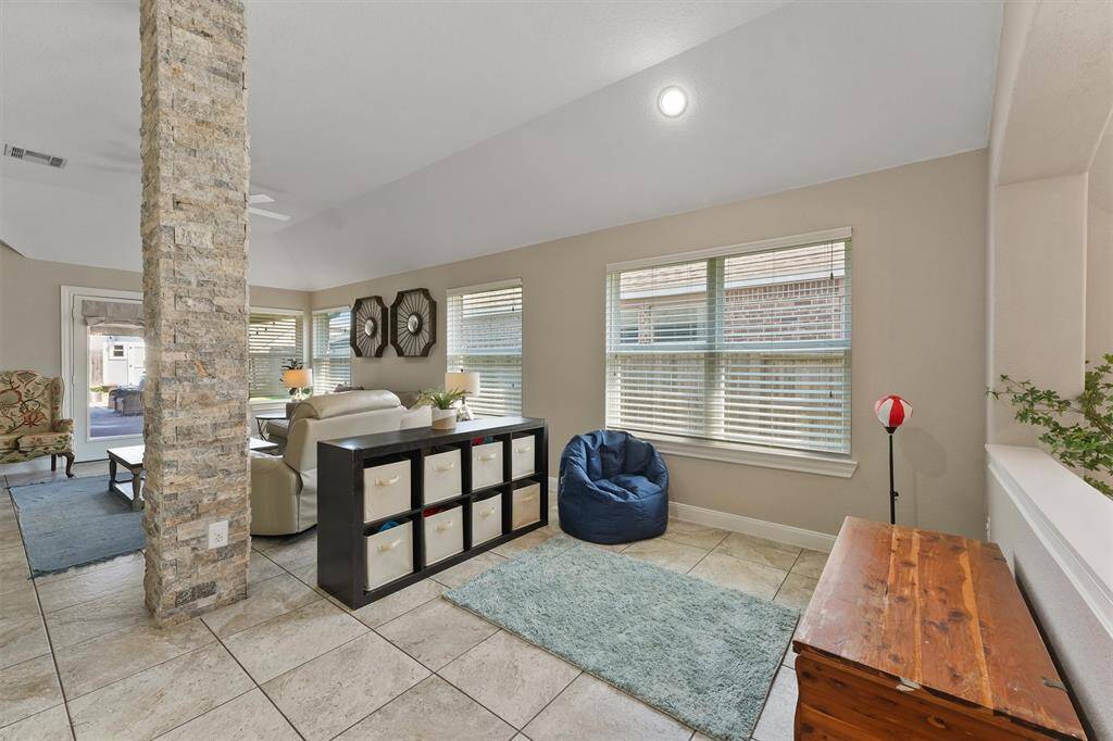 Past the kitchen is a flexible area ideal for a breakfast nook or cozy lounge.