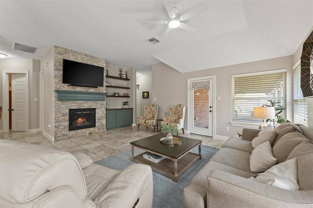 The family room is centered around a custom mantel and built-in, with the fireplace serving as a striking focal point.