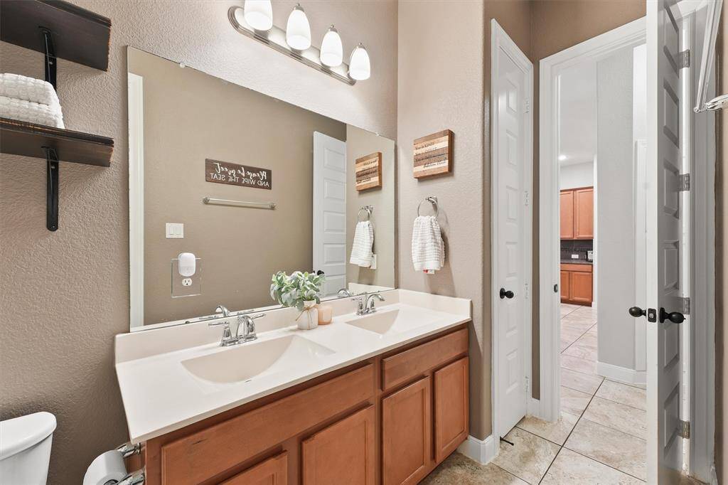 The secondary bathroom features double sinks, offering both functionality and style.