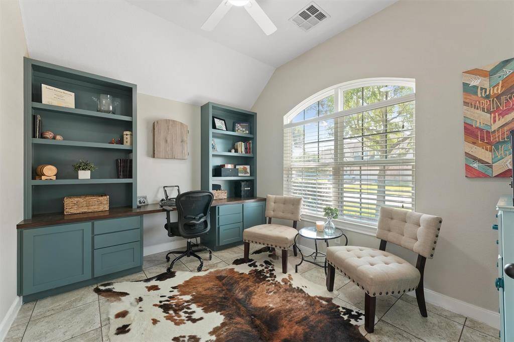 Fnd a dedicated home office to your right, featuring custom built-ins that blend style and productivity.
