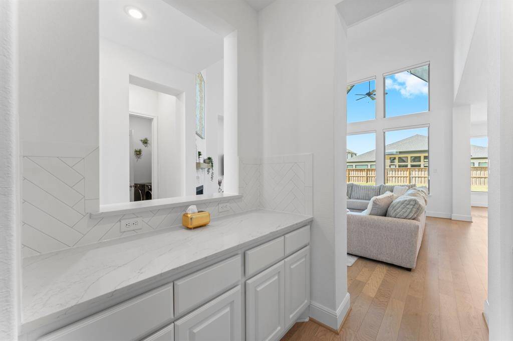 This butler's pantry area provides additional cabinetry/countertop space and features a lovely picture frame opening!