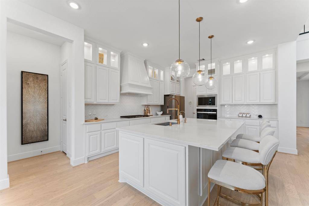 Luxury quartz countertops, an oversized single bowl sink plus a stylish vent hood!