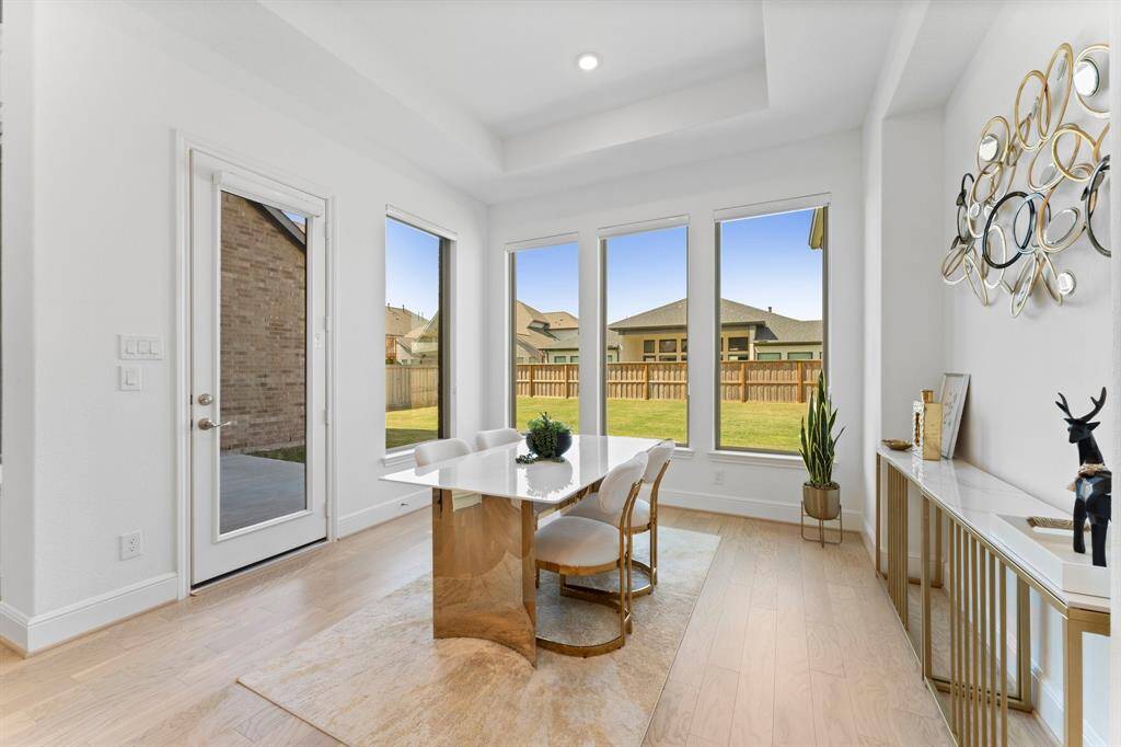 The breakfast nook features an elegant tray ceiling and beautiful oversized windows that let in a lot of natural light!
