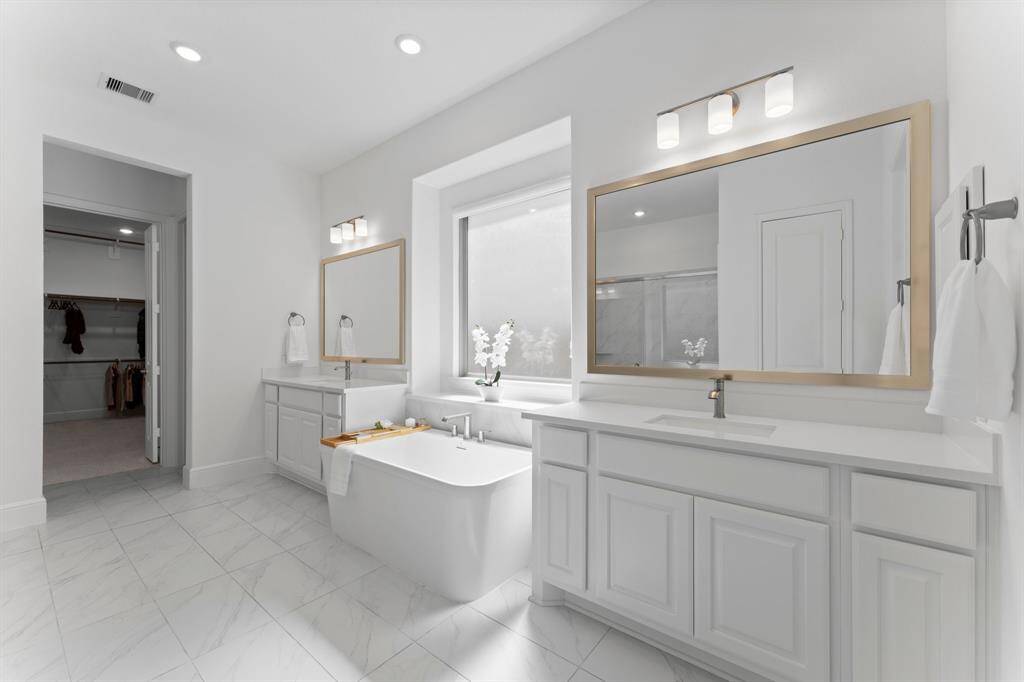 The framed mirrors and the elegant lighting fixtures offer a beautiful contrast that blends extremely well!