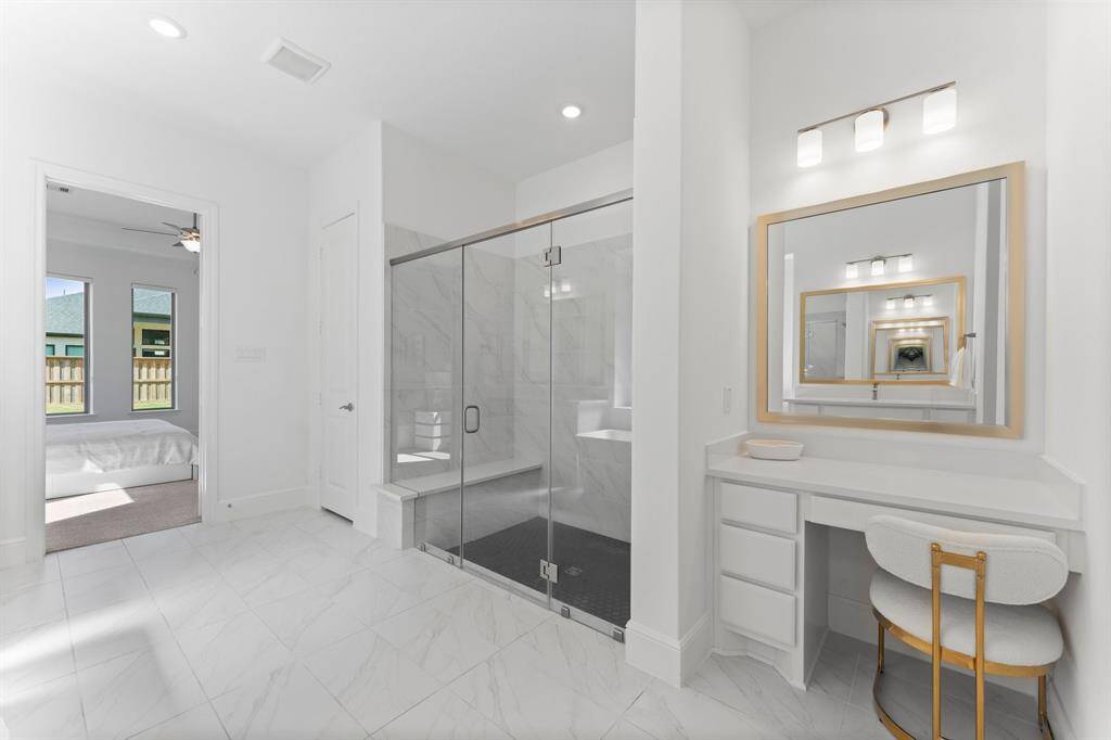 The separate vanity space is an amazing feature of this stunning primary bathroom!