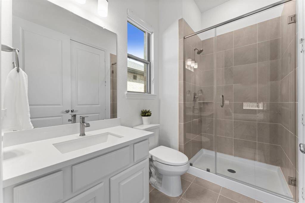 The secondary bedroom downstairs features this private en-suite bathroom with a convenient walk-in shower!