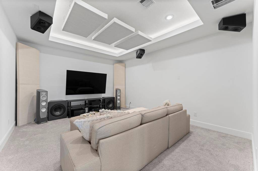 Movie nights just got an upgrade—this spacious media room features a lovely tray ceiling, soundproofing and pre-wire for a 11.2 speaker system!
