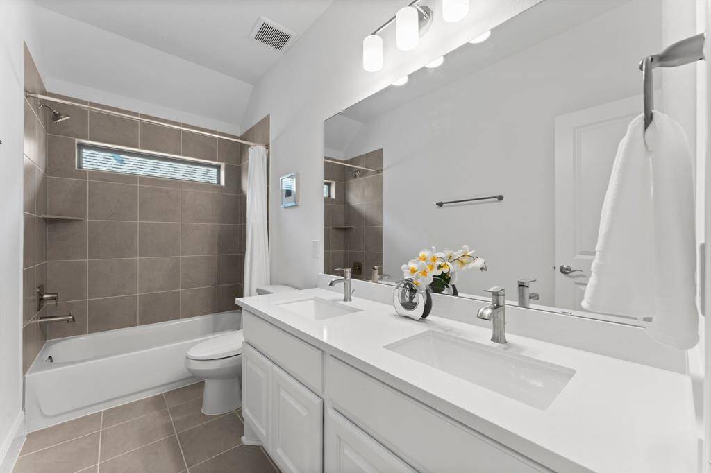 Crisp, clean, and beautifully designed—this double vanity bathroom offers excellent functionality!