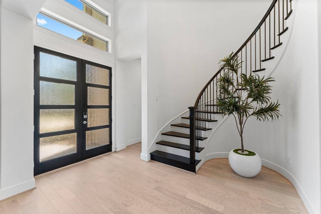 Upgraded luxury white oak engineered hardwood floors + a modern frosted glass and mahogany wood double front door!