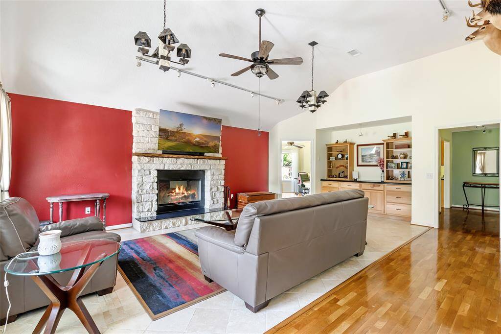 Family room with wood burning white limestone fireplace