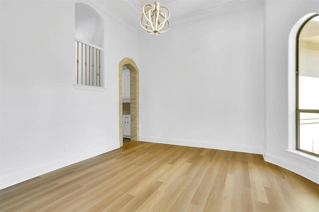 You and your guests will certainly dine in style in this amazing formal dining room! Featuring a gorgeous chandelier, large arched windows, neutral paint, high ceilings and wood flooring. Perfect space to entertain family and friends.