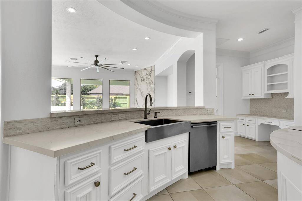 You will love the details of this kitchen! It features a large single basin sink and modern back faucet, white cabinet hardware, quartz counters, and a large kitchen island.