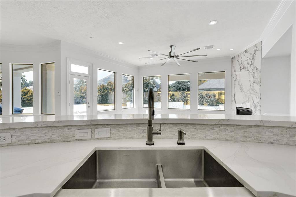 You will love the details of this kitchen! It features a large single basin sink and modern back faucet, white cabinet hardware, quartz counters, and a large kitchen island.