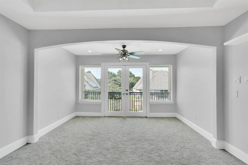 The upstairs game room offers ample entertainment space and features beautiful large windows and French doors that open to a balcony overlooking your pool.