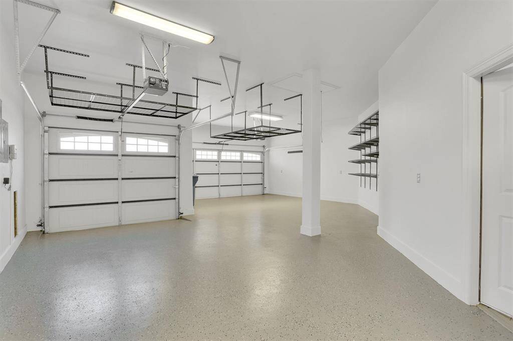 This garage is HUGE with plenty of shelves for storage.