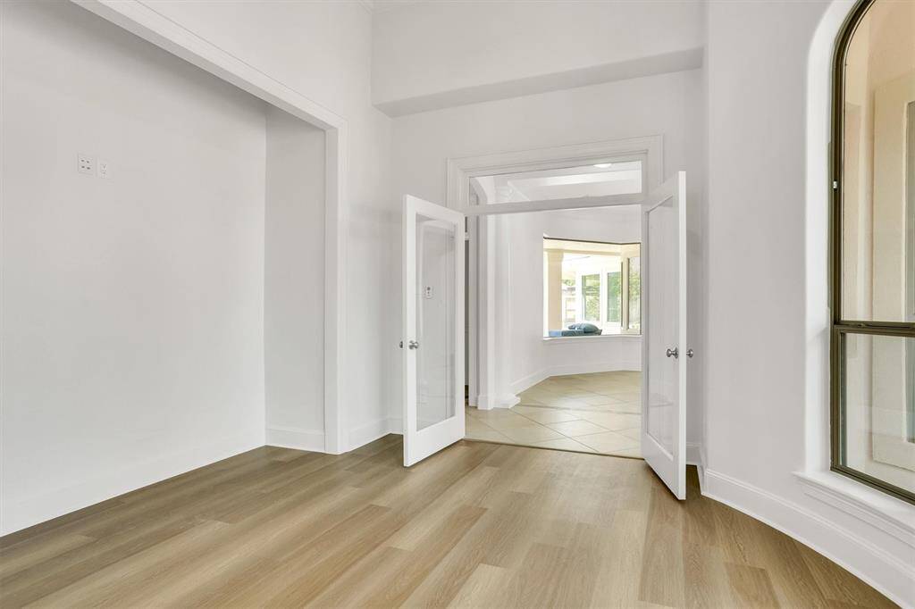 This beautiful white french doors leads to your home office/study room.