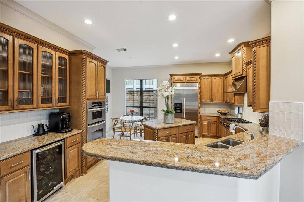 Island Kitchen complete with coffee bar, wine fridge, stainless anppliances and ample storage.