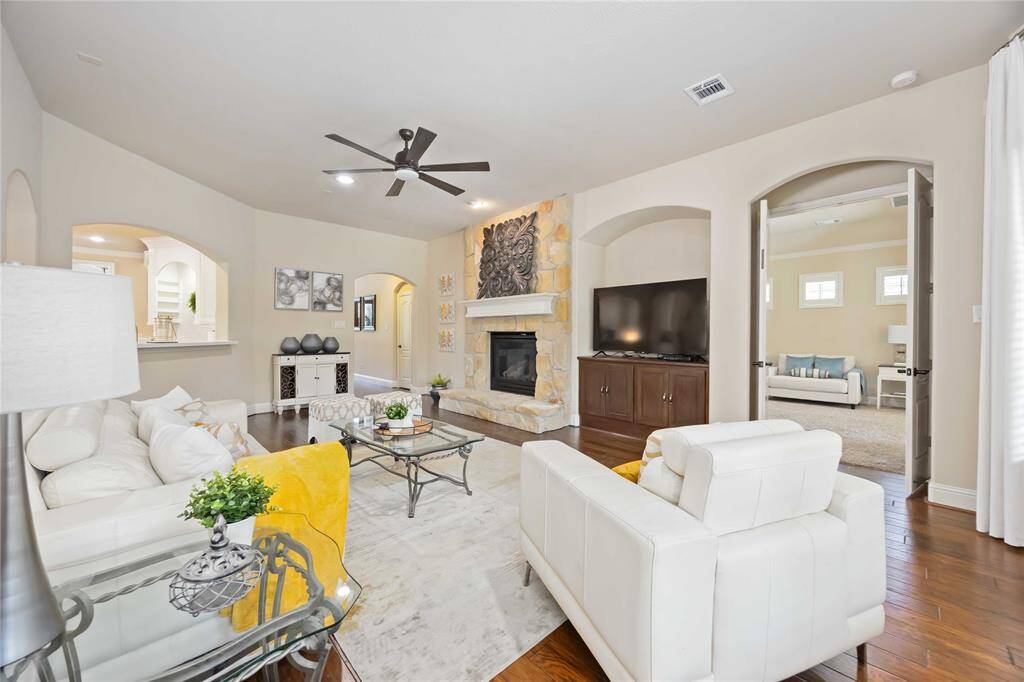 Embrace the warmth of the cozy family room, where the soft glow of the fireplace creates an inviting atmosphere.
