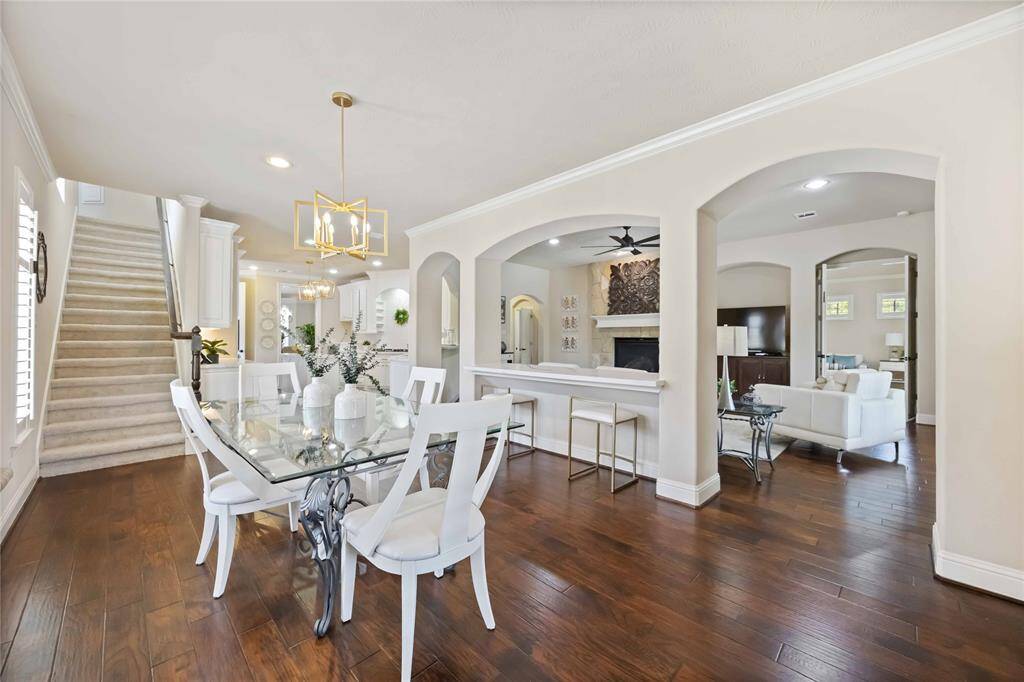 Brunch in a spacious breakfast area can be a delightful experience. The bright, open atmosphere allows natural light to pour in, enhancing the meal's flavors and the overall enjoyment.  The back stairway leads to the media room lounge, media room and bedrooms.