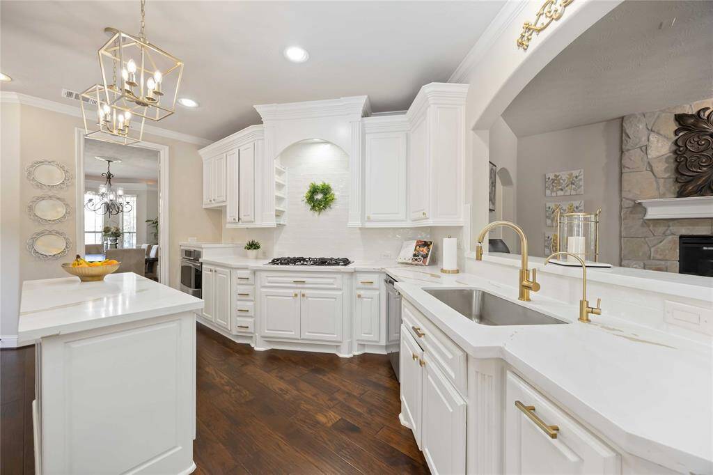 Updated kitchen is both spacious and functional! With ample space, it allows for easier movement while cooking and entertaining.
