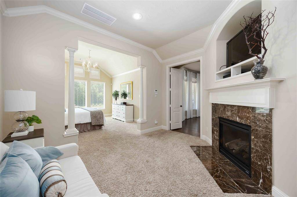 This spacious retreat features a cozy sitting room, ideal for relaxation or reading.