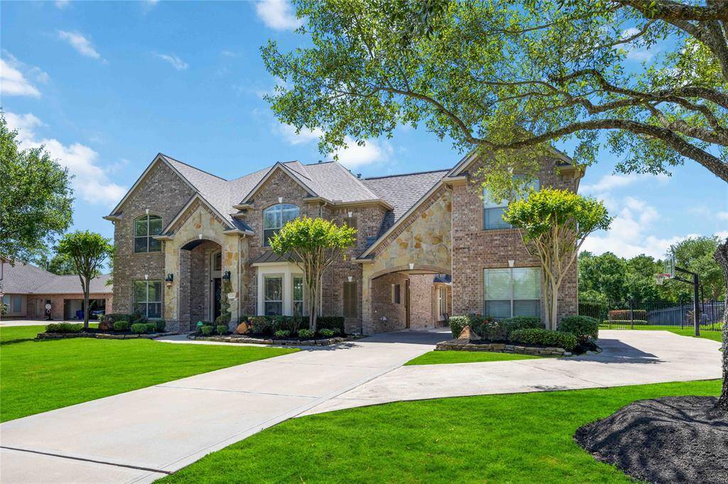 The front of the house boasts an accommodating extended driveway, complemented by an elegant portes-cochère and a convenient side driveway, ensuring there's always ample space for guests to arrive and park.