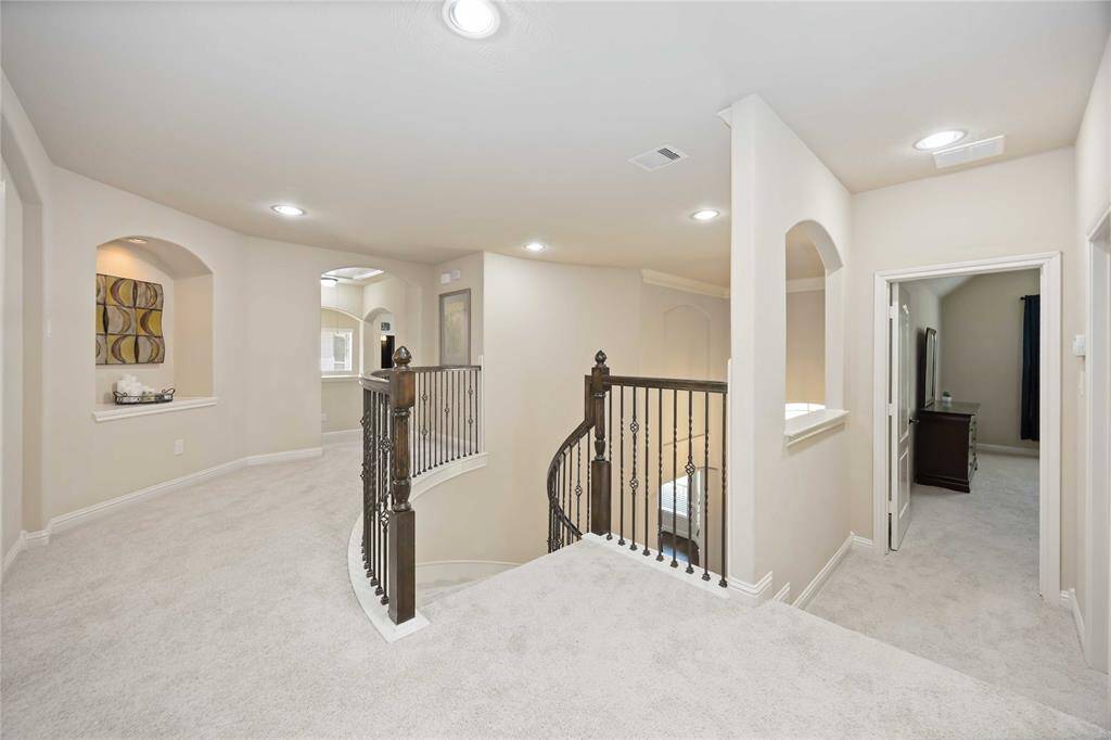 The area upstairs, outside the game room, reveals the front stairwell and adjacent room quarters.