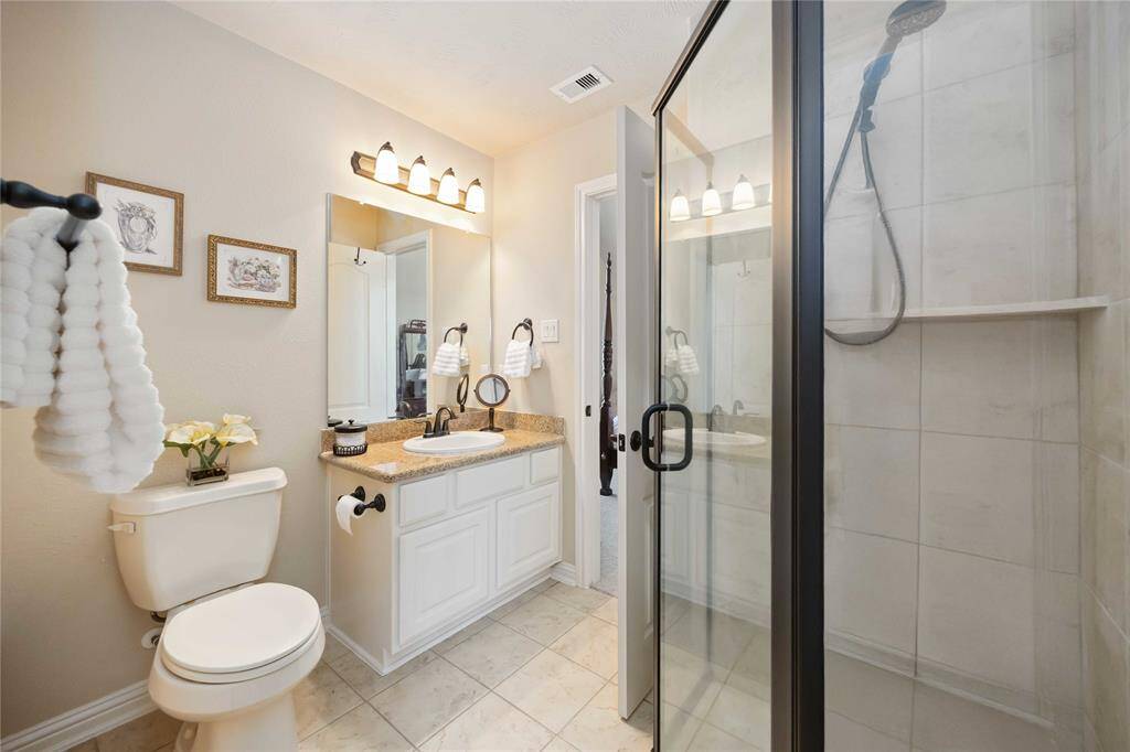 Bathroom for the second bedroom featuring a standing shower and two exit doors.