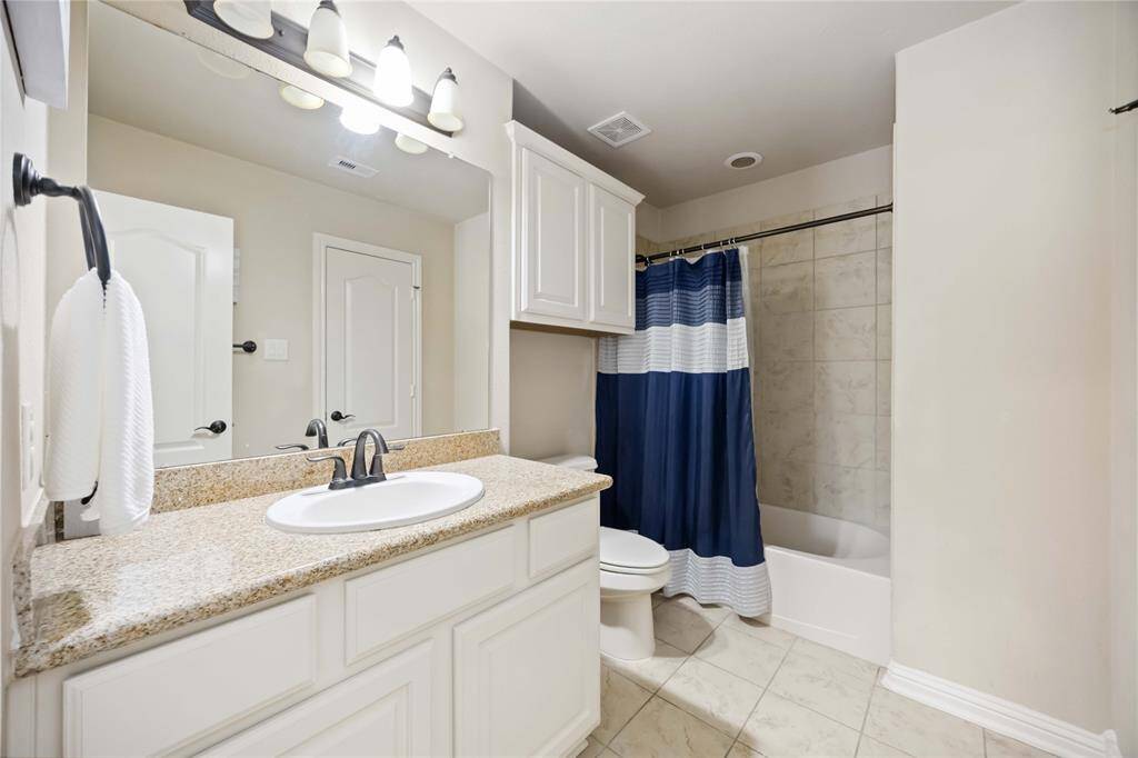 This spacious bathroom serves the fourth bedroom and features a tub-shower combination.