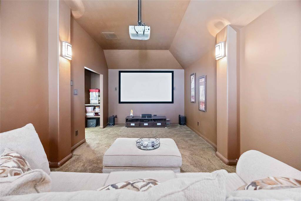 Upstairs, you'll find a spacious media room perfect for entertaining, complete with an area for popcorn and snacks.